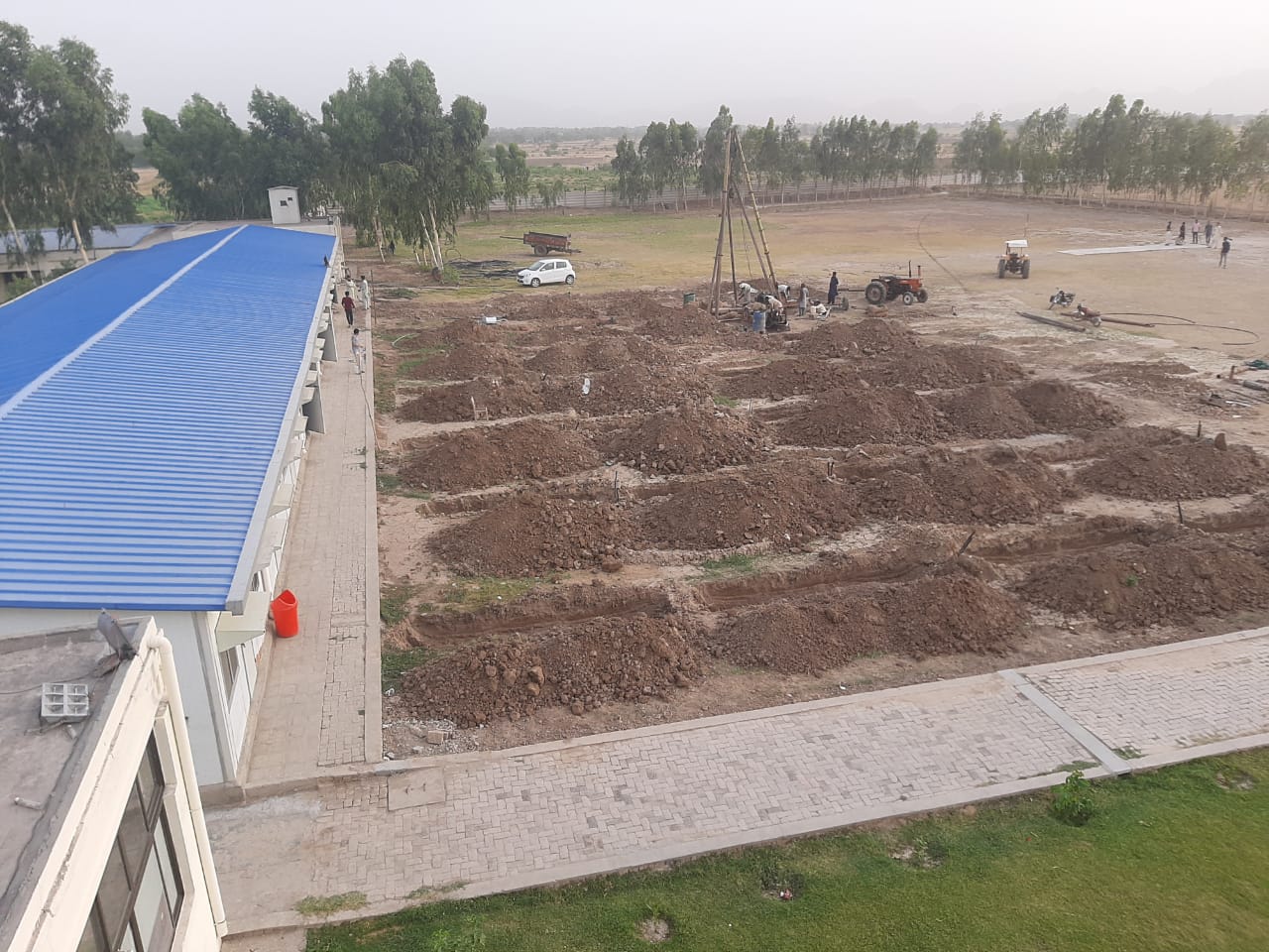 Geothermal borefield connections beside a completed building